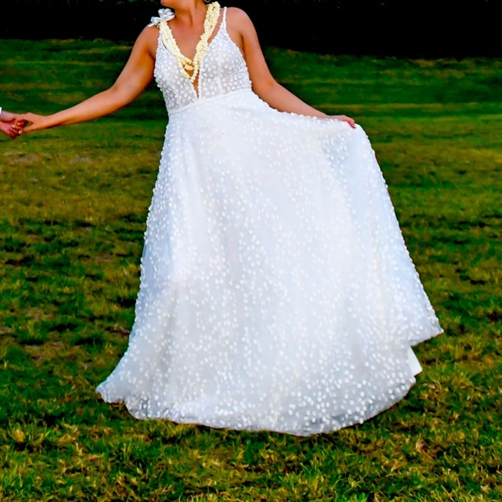 Wedding dress. Size 12. Altered slightly in strap and bustled.